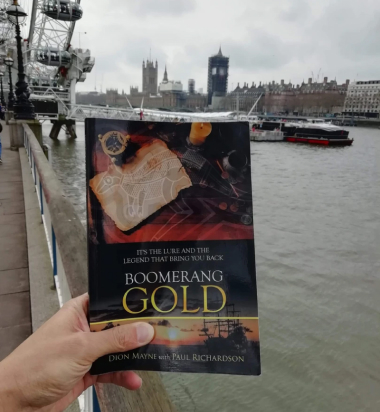 Reading Boomerang Gold at ship port by Dion Mayne Award-winning Historical Fiction Author